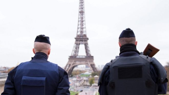Police officers patrol near the Eiffel tower in Paris. EPA