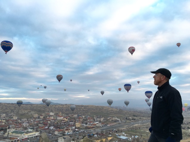 Looking on to the hot air balloons lifting over the Cappadocian Valley
